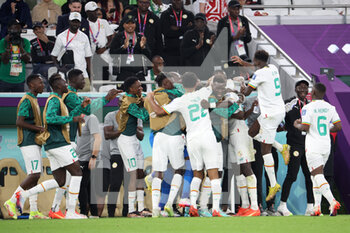 2022-11-25 - Famara Diedhiou of Senegal celebrates his goal with teammates during the FIFA World Cup 2022, Group A football match between Qatar and Senegal on November 25, 2022 at Al Thumama Stadium in Doha, Qatar - FOOTBALL - WORLD CUP 2022 - QATAR V SENEGAL - FIFA WORLD CUP - SOCCER