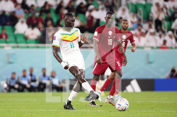 2022-11-25 - Pathe Cisse of Senegal, Almoez Ali of Qatar during the FIFA World Cup 2022, Group A football match between Qatar and Senegal on November 25, 2022 at Al Thumama Stadium in Doha, Qatar - FOOTBALL - WORLD CUP 2022 - QATAR V SENEGAL - FIFA WORLD CUP - SOCCER