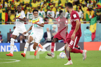 2022-11-25 - Almoez Ali of Qatar, Abdou Diallo of Senegal (left) during the FIFA World Cup 2022, Group A football match between Qatar and Senegal on November 25, 2022 at Al Thumama Stadium in Doha, Qatar - FOOTBALL - WORLD CUP 2022 - QATAR V SENEGAL - FIFA WORLD CUP - SOCCER