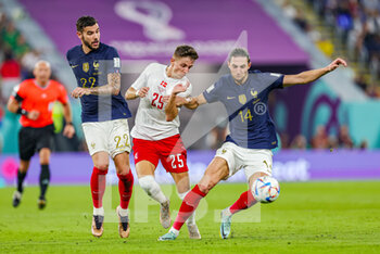 2022-11-26 - Jesper Lindstrom (25) of Denmark battles with Theo Hernandez, Adrien Rabiot of France during the FIFA World Cup 2022, Group D football match between France and Denmark on November 26, 2022 at Stadium 974 in Doha, Qatar - FOOTBALL - WORLD CUP 2022 - FRANCE V DENMARK - FIFA WORLD CUP - SOCCER
