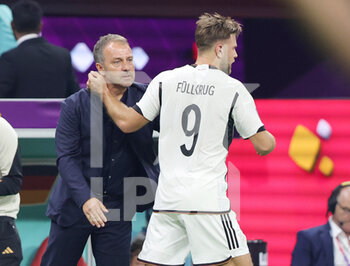 2022-11-27 - Niclas Fullkrug of Germany celebrates his goal 1-1 with head coach Hansi Flick during the FIFA World Cup 2022, Group E football match between Spain and Germany on November 27, 2022 at Al Bayt Stadium in Al Khor, Qatar - FOOTBALL - WORLD CUP 2022 - SPAIN V GERMANY - FIFA WORLD CUP - SOCCER