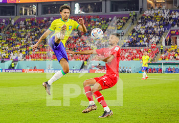 2022-11-29 - Marquinhos (4) of Brazil lifts the ball over Djibril Sow (15) of Switzerland during the FIFA World Cup 2022, Group G football match between Brazil and Switzerland on November 28, 2022 at Stadium 974 in Doha, Qatar - FOOTBALL - WORLD CUP 2022 - BRAZIL V SWITZERLAND - FIFA WORLD CUP - SOCCER