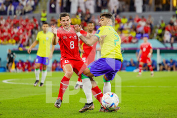 2022-11-29 - Remo Freuler (8) of Switzerland tussles with Lucas Paqueta (7) of Brazil during the FIFA World Cup 2022, Group G football match between Brazil and Switzerland on November 28, 2022 at Stadium 974 in Doha, Qatar - FOOTBALL - WORLD CUP 2022 - BRAZIL V SWITZERLAND - FIFA WORLD CUP - SOCCER