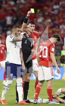 2022-11-29 - Daniel James of Wales receives a yellow card from referee Slavko Vincic of Slovenia during the FIFA World Cup 2022, Group B football match between Wales and England on November 29, 2022 at Ahmad Bin Ali Stadium in Ar-Rayyan, Qatar - FOOTBALL - WORLD CUP 2022 - WALES V ENGLAND - FIFA WORLD CUP - SOCCER