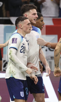 2022-11-29 - Phil Foden of England celebrates his goal with Declan Rice and teammates during the FIFA World Cup 2022, Group B football match between Wales and England on November 29, 2022 at Ahmad Bin Ali Stadium in Ar-Rayyan, Qatar - FOOTBALL - WORLD CUP 2022 - WALES V ENGLAND - FIFA WORLD CUP - SOCCER
