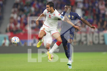 2022-11-30 - Mohamed Ali Ben Romdhane of Tunisia and Randal Kolo Muani of France during the FIFA World Cup 2022, Group D football match between Tunisia and France on November 30, 2022 at Education City Stadium in Doha, Qatar - FOOTBALL - WORLD CUP 2022 - TUNISIA V FRANCE - FIFA WORLD CUP - SOCCER