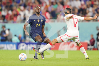 2022-11-30 - Ibrahima Konate of France and Ellyes Skhiri of Tunisia during the FIFA World Cup 2022, Group D football match between Tunisia and France on November 30, 2022 at Education City Stadium in Doha, Qatar - FOOTBALL - WORLD CUP 2022 - TUNISIA V FRANCE - FIFA WORLD CUP - SOCCER