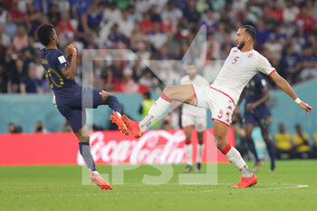 2022-11-30 - Kingsley Coman of France and Nader Ghandri of Tunisia during the FIFA World Cup 2022, Group D football match between Tunisia and France on November 30, 2022 at Education City Stadium in Doha, Qatar - FOOTBALL - WORLD CUP 2022 - TUNISIA V FRANCE - FIFA WORLD CUP - SOCCER