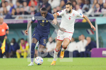 2022-11-30 - Randal Kolo Muani of France and Yassine Meriah of Tunisia during the FIFA World Cup 2022, Group D football match between Tunisia and France on November 30, 2022 at Education City Stadium in Doha, Qatar - FOOTBALL - WORLD CUP 2022 - TUNISIA V FRANCE - FIFA WORLD CUP - SOCCER