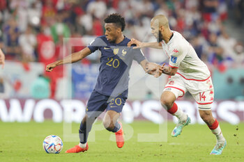 2022-11-30 - Kingsley Coman of France and Aissa Laidouni of Tunisia during the FIFA World Cup 2022, Group D football match between Tunisia and France on November 30, 2022 at Education City Stadium in Doha, Qatar - FOOTBALL - WORLD CUP 2022 - TUNISIA V FRANCE - FIFA WORLD CUP - SOCCER
