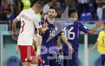 2022-11-30 - Lionel Messi of Argentina salutes Artur Jedrzejczyk of Poland (left) following the FIFA World Cup 2022, Group C football match between Poland and Argentina on November 30, 2022 at Stadium 974 in Doha, Qatar - FOOTBALL - WORLD CUP 2022 - POLAND V ARGENTINA - FIFA WORLD CUP - SOCCER