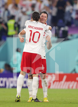 2022-11-30 - Grzegorz Krychowiak and Robert Lewandowski of Poland celebrate the qualification at full time during the FIFA World Cup 2022, Group C football match between Poland and Argentina on November 30, 2022 at Stadium 974 in Doha, Qatar - FOOTBALL - WORLD CUP 2022 - POLAND V ARGENTINA - FIFA WORLD CUP - SOCCER