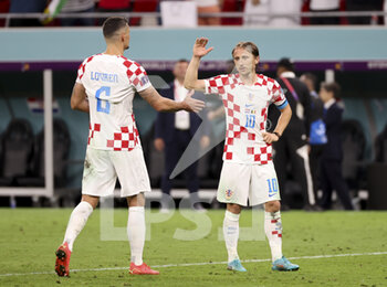 2022-12-01 - Luka Modric, Dejan Lovren (left) of Croatia celebrate the victory with the fans following the FIFA World Cup 2022, Group F football match between Croatia and Belgium on December 1, 2022 at Ahmad Bin Ali Stadium in Ar-Rayyan, Qatar - FOOTBALL - WORLD CUP 2022 - CROATIA V BELGIUM - FIFA WORLD CUP - SOCCER
