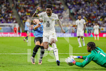 2022-12-02 - Facundo Pellistri (8) of Uruguay goes down under the challenge from Daniel Amartey (18) of Ghana during the FIFA World Cup 2022, Group H football match between Ghana and Uruguay on December 2, 2022 at Al-Janoub Stadium in Al-Wakrah, Qatar - FOOTBALL - WORLD CUP 2022 - GHANA V URUGUAY - FIFA WORLD CUP - SOCCER
