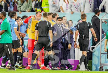 2022-12-02 - Uruguay are held back by security to allow the referree to leave the field during the FIFA World Cup 2022, Group H football match between Ghana and Uruguay on December 2, 2022 at Al-Janoub Stadium in Al-Wakrah, Qatar - FOOTBALL - WORLD CUP 2022 - GHANA V URUGUAY - FIFA WORLD CUP - SOCCER
