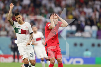 2022-12-02 - Gue-sung Cho of Korea Republic and Joao Cancelo of Portugal during the FIFA World Cup 2022, Group H football match between Korea Republic and Portugal on December 2, 2022 at Education City Stadium in Doha, Qatar - FOOTBALL - WORLD CUP 2022 - KOREA REPUBLIC V PORTUGAL - FIFA WORLD CUP - SOCCER