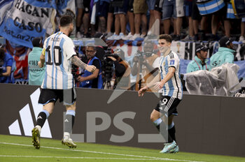 2022-12-03 - Julian Alvarez of Argentina celebrates his goal with Lionel Messi (left) during the FIFA World Cup 2022, Round of 16 football match between Argentina and Australia on December 3, 2022 at Ahmad Bin Ali Stadium in Al Rayyan, Qatar - FOOTBALL - WORLD CUP 2022 - 1/8 - ARGENTINA V AUSTRALIA - FIFA WORLD CUP - SOCCER