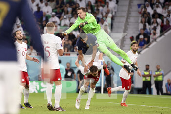 2022-12-04 - From top, Poland goalkeeper Wojciech Szczesny, Raphael Varane of France, Matty Cash of Poland during the FIFA World Cup 2022, Round of 16 football match between France and Poland on December 4, 2022 at Al Thumama Stadium in Doha, Qatar - FOOTBALL - WORLD CUP 2022 - 1/8 - FRANCE V POLAND - FIFA WORLD CUP - SOCCER