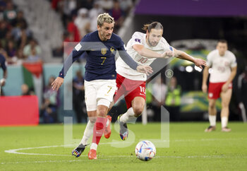 2022-12-04 - Antoine Griezmann of France, Grzegorz Krychowiak of Poland during the FIFA World Cup 2022, Round of 16 football match between France and Poland on December 4, 2022 at Al Thumama Stadium in Doha, Qatar - FOOTBALL - WORLD CUP 2022 - 1/8 - FRANCE V POLAND - FIFA WORLD CUP - SOCCER