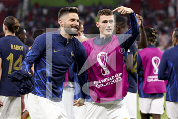2022-12-04 - Olivier Giroud. Benjamin Pavard of France celebrate the victory following the FIFA World Cup 2022, Round of 16 football match between France and Poland on December 4, 2022 at Al Thumama Stadium in Doha, Qatar - FOOTBALL - WORLD CUP 2022 - 1/8 - FRANCE V POLAND - FIFA WORLD CUP - SOCCER