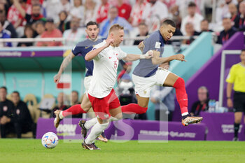 2022-12-04 - Kylian Mbappe of France, Kamil Glik of Poland during the FIFA World Cup 2022, Round of 16 football match between France and Poland on December 4, 2022 at Al Thumama Stadium in Doha, Qatar - FOOTBALL - WORLD CUP 2022 - 1/8 - FRANCE V POLAND - FIFA WORLD CUP - SOCCER