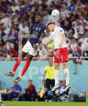 2022-12-04 - Marcus Thuram of France, Krystian Bielik of Poland during the FIFA World Cup 2022, Round of 16 football match between France and Poland on December 4, 2022 at Al Thumama Stadium in Doha, Qatar - FOOTBALL - WORLD CUP 2022 - 1/8 - FRANCE V POLAND - FIFA WORLD CUP - SOCCER