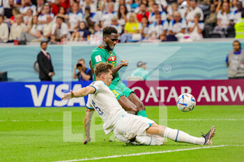 2022-12-04 - Iliman Ndiaye (9) of Senegal, John Stones of England during the FIFA World Cup 2022, Round of 16 football match between England and Senegal on December 4, 2022 at Al Bayt Stadium in Al Khor, Qatar - FOOTBALL - WORLD CUP 2022 - 1/8 - ENGLAND V SENEGAL - FIFA WORLD CUP - SOCCER