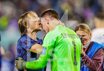 2022-12-05 - Luka Modric (10) of Croatia kisses Dominik Livakovic (1) of Croatia at full time during the FIFA World Cup 2022, Round of 16 football match between Japan and Croatia on December 5, 2022 at Al-Janoub Stadium in Al-Wakrah, Qatar - FOOTBALL - WORLD CUP 2022 - 1/8 - JAPAN V CROATIA - FIFA WORLD CUP - SOCCER