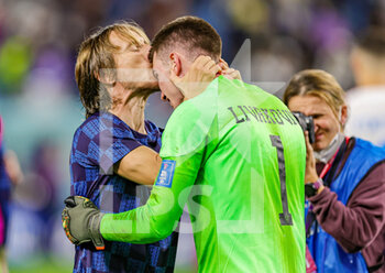 2022-12-05 - Luka Modric (10) of Croatia kisses Dominik Livakovic (1) of Croatia at full time during the FIFA World Cup 2022, Round of 16 football match between Japan and Croatia on December 5, 2022 at Al-Janoub Stadium in Al-Wakrah, Qatar - FOOTBALL - WORLD CUP 2022 - 1/8 - JAPAN V CROATIA - FIFA WORLD CUP - SOCCER