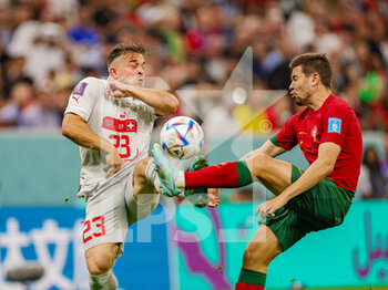 2022-12-06 - Raphael Guerreiro (5) of Portugal tussles with Xherdan Shaqiri (23) of Switzerland during the FIFA World Cup 2022, Round of 16 football match between Portugal and Switzerland on December 6, 2022 at Lusail Stadium in Al Daayen, Qatar - FOOTBALL - WORLD CUP 2022 - 1/8 - PORTUGAL V SWITZERLAND - FIFA WORLD CUP - SOCCER