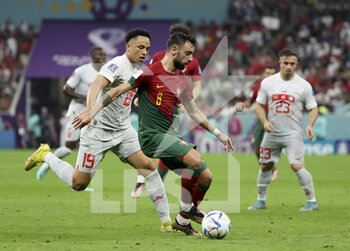 2022-12-06 - Bruno Fernandes of Portugal, Noah Okafor of Switzerland (left) during the FIFA World Cup 2022, Round of 16 football match between Portugal and Switzerland on December 6, 2022 at Lusail Stadium in Al Daayen, Qatar - FOOTBALL - WORLD CUP 2022 - 1/8 - PORTUGAL V SWITZERLAND - FIFA WORLD CUP - SOCCER