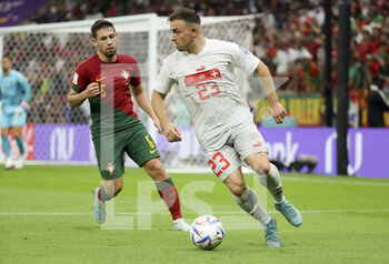 2022-12-06 - Xherdan Shaqiri of Switzerland, Raphael Guerreiro of Portugal (left) during the FIFA World Cup 2022, Round of 16 football match between Portugal and Switzerland on December 6, 2022 at Lusail Stadium in Al Daayen, Qatar - FOOTBALL - WORLD CUP 2022 - 1/8 - PORTUGAL V SWITZERLAND - FIFA WORLD CUP - SOCCER