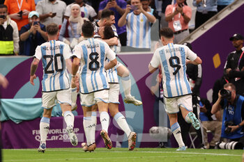 2022-12-09 - Nahuel Molina of Argentina celebrates with Lionel Messi of Argentina and teammates after scoring the team's first goal during the FIFA World Cup 2022, Quarter-final football match between Netherlands and Argentina on December 9, 2022 at Lusail Stadium in Al Daayen, Qatar - FOOTBALL - WORLD CUP 2022 - 1/4 - NETHERLANDS V ARGENTINA - FIFA WORLD CUP - SOCCER