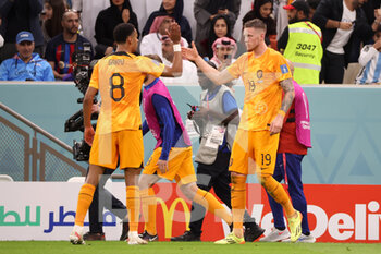 2022-12-09 - Wout Weghorst of Netherlands celebrates with Cody Gakpo of Netherlands after scoring a goal to make it 2-2 during the FIFA World Cup 2022, Quarter-final football match between Netherlands and Argentina on December 9, 2022 at Lusail Stadium in Al Daayen, Qatar - FOOTBALL - WORLD CUP 2022 - 1/4 - NETHERLANDS V ARGENTINA - FIFA WORLD CUP - SOCCER