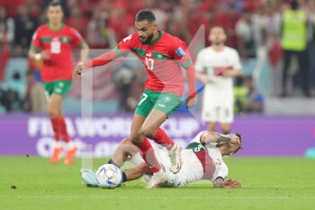 2022-12-10 - Sofiane Boufal of Morocco and Otavio of Portugal during the FIFA World Cup 2022, Quarter-final football match between Morocco and Portugal on December 10, 2022 at Al Thumama Stadium in Doha, Qatar - FOOTBALL - WORLD CUP 2022 - 1/4 - MOROCCO V PORTUGAL - FIFA WORLD CUP - SOCCER