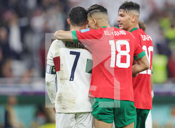 2022-12-10 - Cristiano Ronaldo of Portugal and Jawad El Yamiq of Morocco at full time during the FIFA World Cup 2022, Quarter-final football match between Morocco and Portugal on December 10, 2022 at Al Thumama Stadium in Doha, Qatar - FOOTBALL - WORLD CUP 2022 - 1/4 - MOROCCO V PORTUGAL - FIFA WORLD CUP - SOCCER