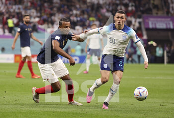 2022-12-10 - Phil Foden of England, Jules Kounde of France (left) during the FIFA World Cup 2022, Quarter-final football match between England and France on December 10, 2022 at Al Bayt Stadium in Al Khor, Qatar - FOOTBALL - WORLD CUP 2022 - 1/4 - ENGLAND V FRANCE - FIFA WORLD CUP - SOCCER