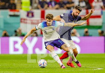 2022-12-10 - John Stones (5) of England turns Olivier Giroud (9) of France during the FIFA World Cup 2022, Quarter-final football match between England and France on December 10, 2022 at Al Bayt Stadium in Al Khor, Qatar - FOOTBALL - WORLD CUP 2022 - 1/4 - ENGLAND V FRANCE - FIFA WORLD CUP - SOCCER