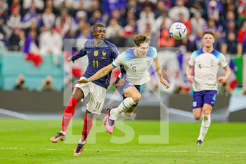 2022-12-10 - John Stones (5) of England is fouled by Ousmane Dembele (11) of France during the FIFA World Cup 2022, Quarter-final football match between England and France on December 10, 2022 at Al Bayt Stadium in Al Khor, Qatar - FOOTBALL - WORLD CUP 2022 - 1/4 - ENGLAND V FRANCE - FIFA WORLD CUP - SOCCER