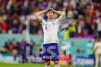2022-12-10 - John Stones (5) of England looks devastated at full time during the FIFA World Cup 2022, Quarter-final football match between England and France on December 10, 2022 at Al Bayt Stadium in Al Khor, Qatar - FOOTBALL - WORLD CUP 2022 - 1/4 - ENGLAND V FRANCE - FIFA WORLD CUP - SOCCER