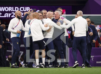 2022-12-10 - Coach of France Didier Deschamps hugging his assistant-coach Guy Stephan celebrate with staff the victory following the FIFA World Cup 2022, Quarter-final football match between England and France on December 10, 2022 at Al Bayt Stadium in Al Khor, Qatar - FOOTBALL - WORLD CUP 2022 - 1/4 - ENGLAND V FRANCE - FIFA WORLD CUP - SOCCER