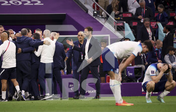 2022-12-10 - Coach of England Gareth Southgate comes to congratulate coach of France Didier Deschamps and his staff at final whistle during the FIFA World Cup 2022, Quarter-final football match between England and France on December 10, 2022 at Al Bayt Stadium in Al Khor, Qatar - FOOTBALL - WORLD CUP 2022 - 1/4 - ENGLAND V FRANCE - FIFA WORLD CUP - SOCCER