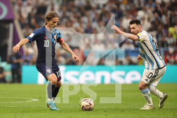 2022-12-13 - Luka Modric of Croatia, Lionel Messi of Argentina during the FIFA World Cup 2022, Semi-final football match between Argentina and Croatia on December 13, 2022 at Lusail Stadium in Al Daayen, Qatar - FOOTBALL - WORLD CUP 2022 - 1/2 - ARGENTINA V CROATIA - FIFA WORLD CUP - SOCCER