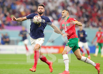 2022-12-14 - Olivier Giroud of France and Romain Saiss of Morocco during the FIFA World Cup 2022, Semi-final football match between France and Morocco on December 14, 2022 at Al Bayt Stadium in Al Khor, Qatar - FOOTBALL - WORLD CUP 2022 - 1/2 - FRANCE V MOROCCO - FIFA WORLD CUP - SOCCER