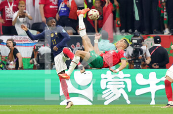 2022-12-14 - Jawad El-Yamiq of Morocco and Ousmane Dembele of France during the FIFA World Cup 2022, Semi-final football match between France and Morocco on December 14, 2022 at Al Bayt Stadium in Al Khor, Qatar - FOOTBALL - WORLD CUP 2022 - 1/2 - FRANCE V MOROCCO - FIFA WORLD CUP - SOCCER