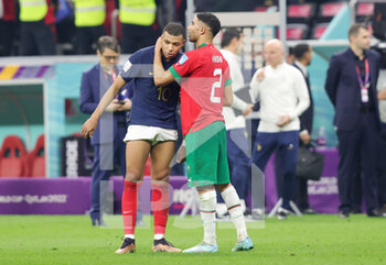 2022-12-14 - Paris Saint-Germain teammates Kylian Mbappe of France and Achraf Hakimi of Morocco at full time during the FIFA World Cup 2022, Semi-final football match between France and Morocco on December 14, 2022 at Al Bayt Stadium in Al Khor, Qatar - FOOTBALL - WORLD CUP 2022 - 1/2 - FRANCE V MOROCCO - FIFA WORLD CUP - SOCCER