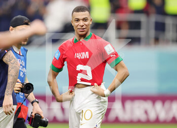 2022-12-14 - Kylian Mbappe of France with the shirt of Achraf Hakimi of Morocco at full time during the FIFA World Cup 2022, Semi-final football match between France and Morocco on December 14, 2022 at Al Bayt Stadium in Al Khor, Qatar - FOOTBALL - WORLD CUP 2022 - 1/2 - FRANCE V MOROCCO - FIFA WORLD CUP - SOCCER