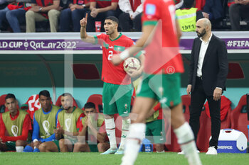 2022-12-14 - Achraf Hakimi of Morocco, Coach of Morocco Walid Regragui during the FIFA World Cup 2022, Semi-final football match between France and Morocco on December 14, 2022 at Al Bayt Stadium in Al Khor, Qatar - FOOTBALL - WORLD CUP 2022 - 1/2 - FRANCE V MOROCCO - FIFA WORLD CUP - SOCCER