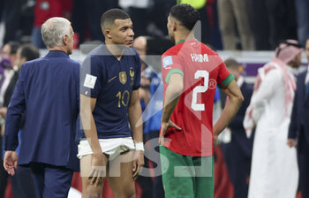 2022-12-14 - Kylian Mbappe of France exchanges his jersey with Achraf Hakimi of Morocco following the FIFA World Cup 2022, Semi-final football match between France and Morocco on December 14, 2022 at Al Bayt Stadium in Al Khor, Qatar - FOOTBALL - WORLD CUP 2022 - 1/2 - FRANCE V MOROCCO - FIFA WORLD CUP - SOCCER