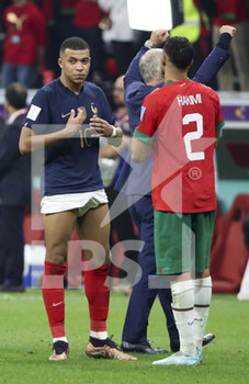 2022-12-14 - Kylian Mbappe of France exchanges his jersey with Achraf Hakimi of Morocco following the FIFA World Cup 2022, Semi-final football match between France and Morocco on December 14, 2022 at Al Bayt Stadium in Al Khor, Qatar - FOOTBALL - WORLD CUP 2022 - 1/2 - FRANCE V MOROCCO - FIFA WORLD CUP - SOCCER